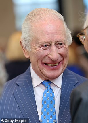 The King opted for a fun castle-themed patterned tie and a smart navy pinstriped suit for the outing