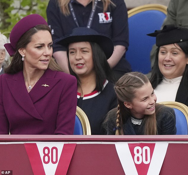 The pair were engrossed in conversation as they watched the parade march in front of Buckingham Palace