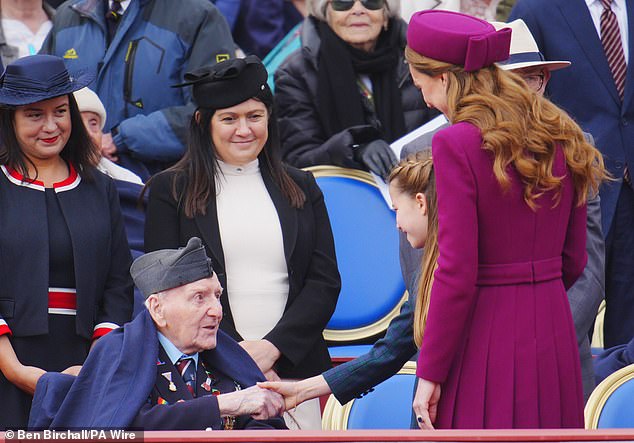 Princess Charlotte shaking hands with Second World War Veteran Bernard Morgan, as the Princess of Wales seemingly made introductions