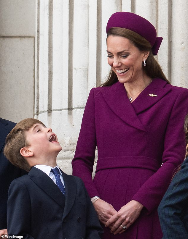 The young prince laughed along with his mother as the family observed the fly-past from the balcony