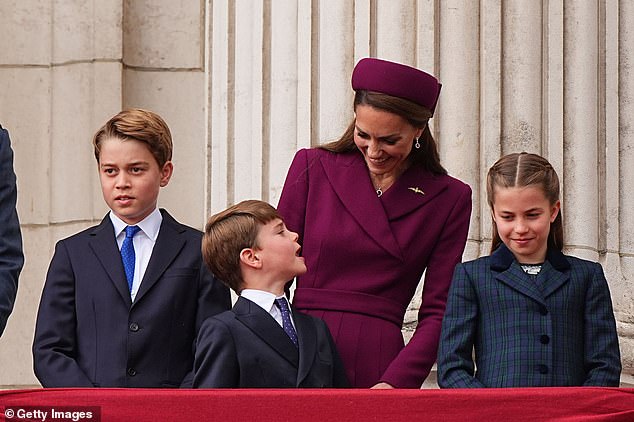 Kate beamed at her young children as they joined her and the Prince of Wales on the balcony yesterday