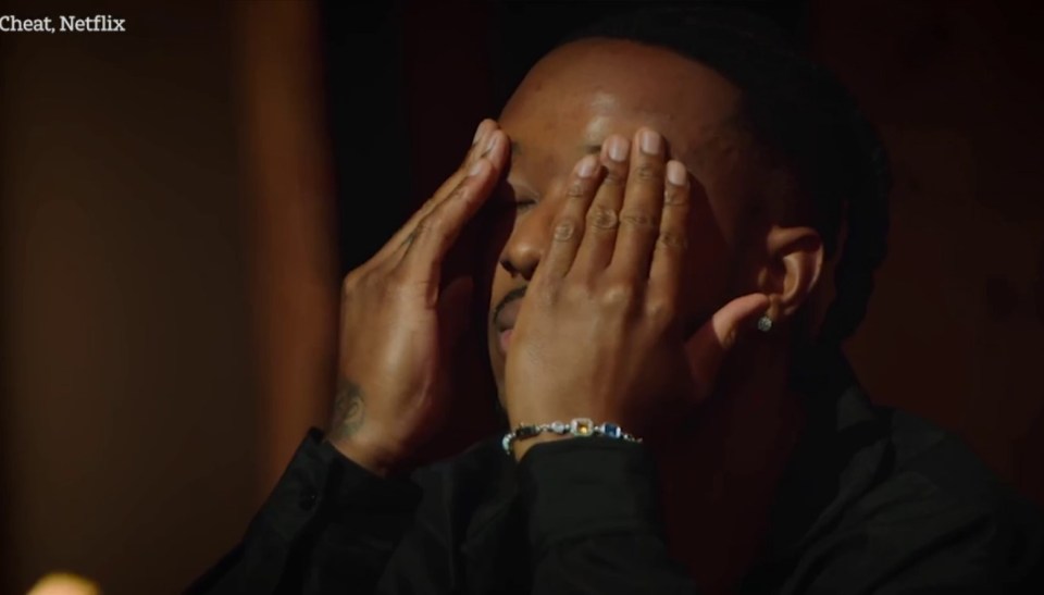 Man covering his face with his hands, appearing upset.