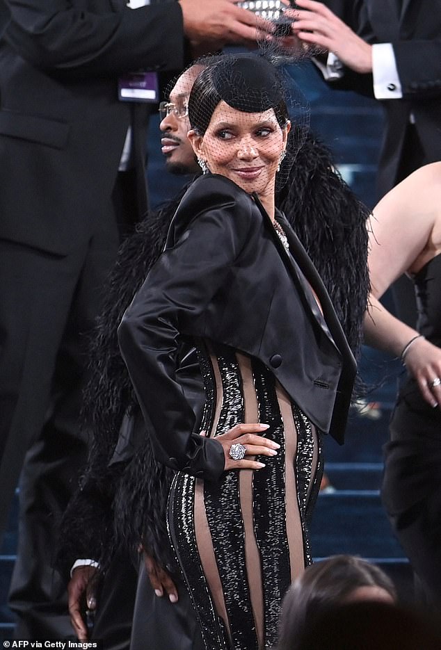 Parts of her midriff and crotch were exposed in the daring ensemble, which she teamed with a cropped black blazer with shoulder pads