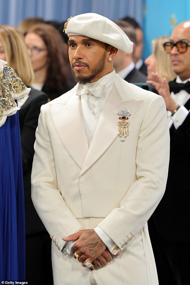 Lewis was dressed in a sharp white look adorned with boucle detailing, teamed with a matching beret with gold embellishment