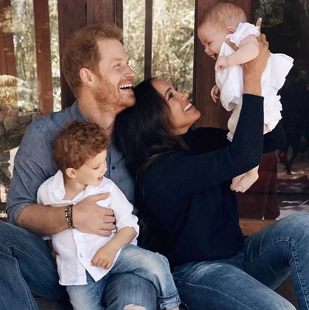 Harry hugs Archie as Meghan raises Lilibet into the air in the first picture of the couple's baby girl released in 2021