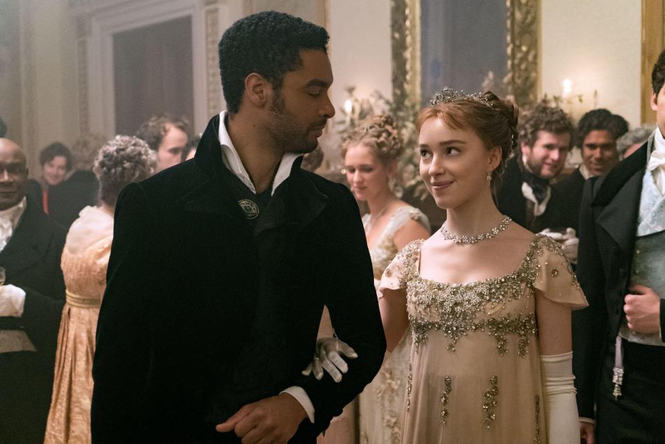 A man and woman in Regency-era attire at a ball.