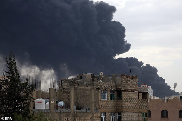 Smoke billows over buildings following Israeli airstrikes in Sana'a, Yemen