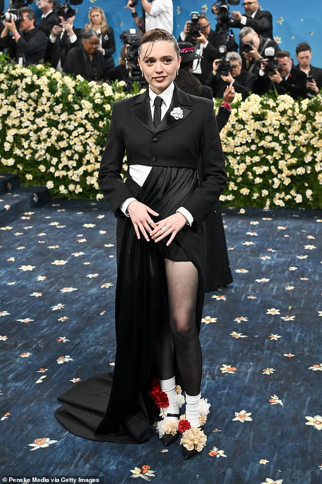 Aimee Lou Wood appeared to have got her suit, by British label Ahluwalia, caught in the door of her limousine before making her entrance on the blue carpet