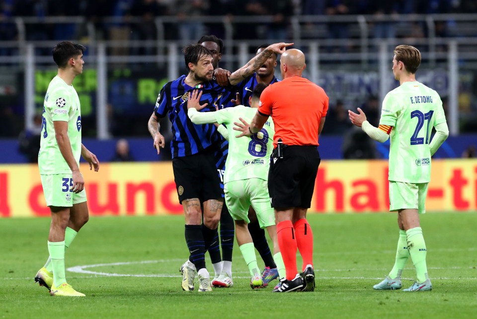 Referee approaches players during a soccer game.