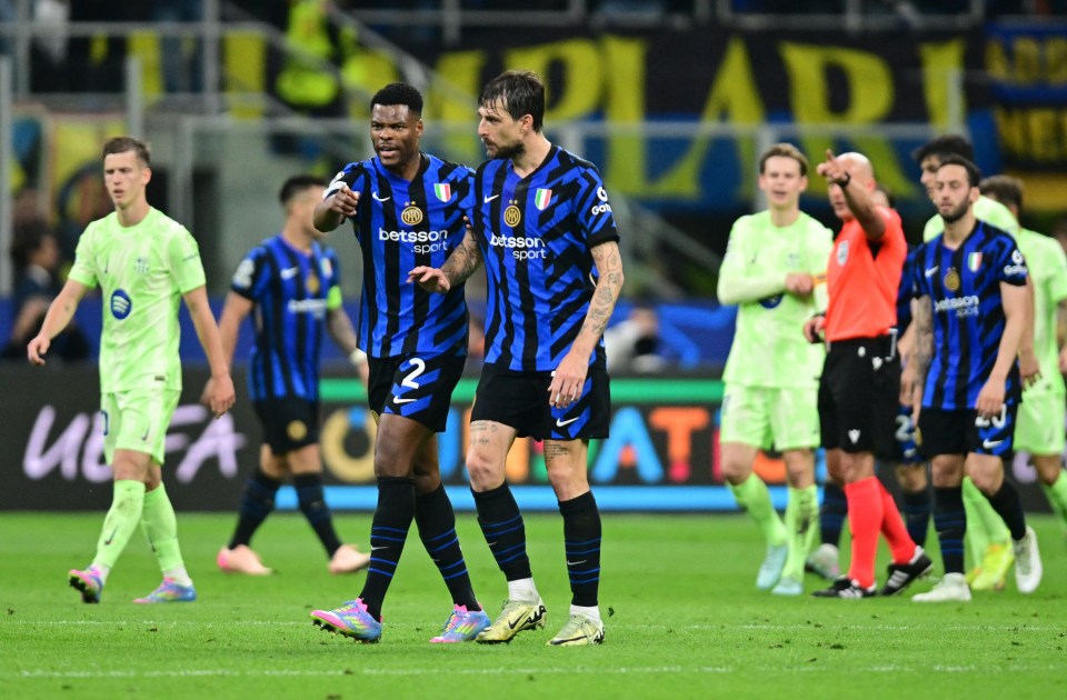 Inter Milan's Denzel Dumfries and Francesco Acerbi on the soccer field.