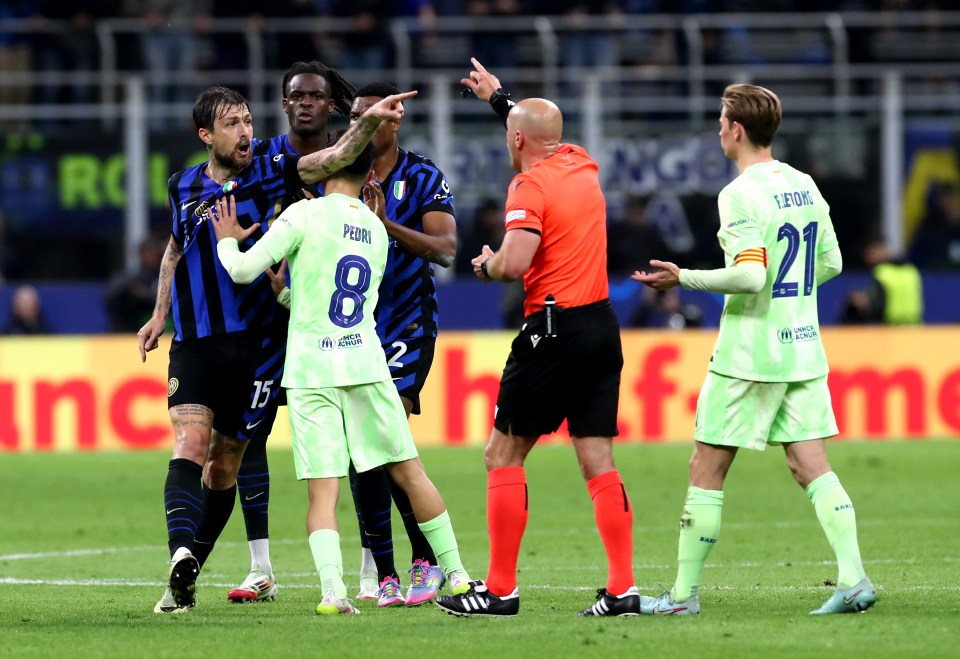 Referee speaking with soccer players.