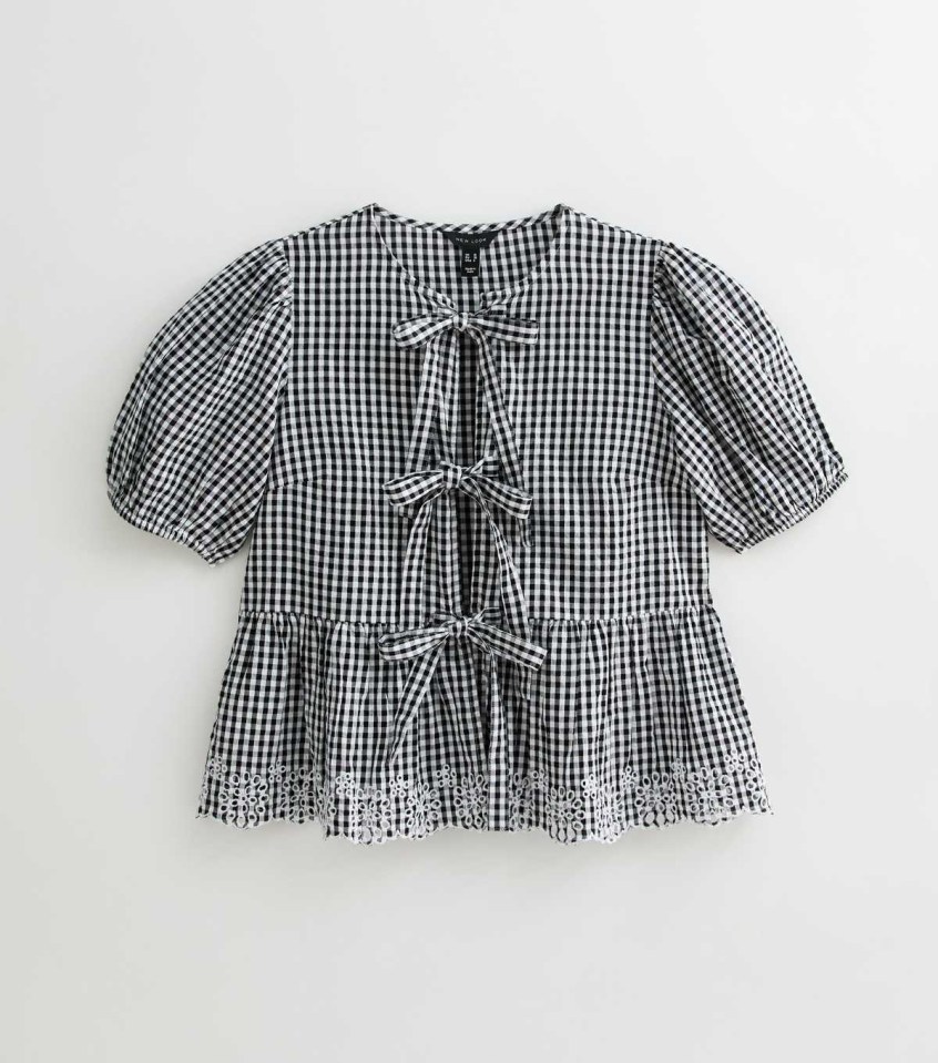 Black and white gingham top with puff sleeves and eyelet trim.