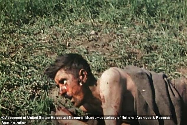 Around 40 seconds later, after the footage has cut to show a bloodied, naked man in a blanket lying on the ground, the woman appears again