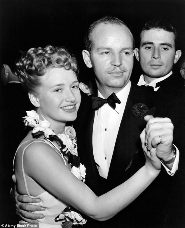 Oren W. Haglund was discharged in December 1945 and became a production manager of TV shows. He died in 1972 aged 66. Above: With his fiancee, the actress, Priscilla Lane in 1939. The couple divorced in 1941