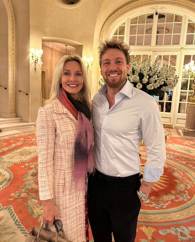 Photo of a woman and a man posing together in a hotel lobby.