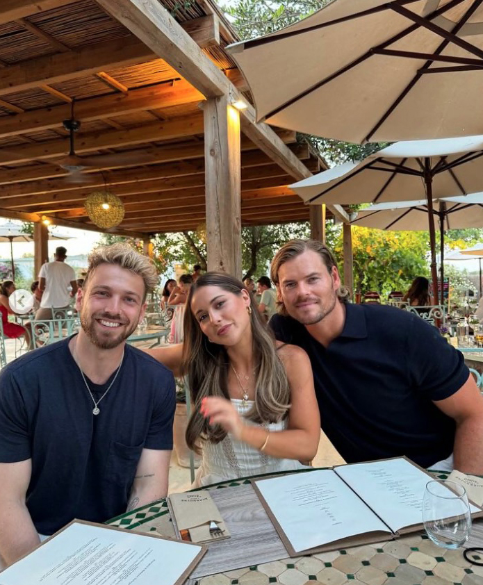 Sam Thompson and Zara McDermott with a friend at an outdoor restaurant.