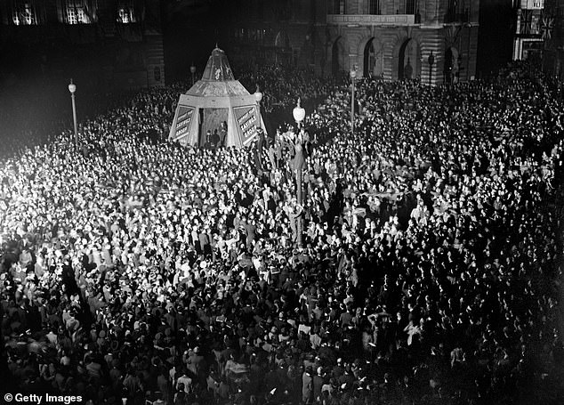 Pictured: VE Day celebrations in London at the end of the Second World War - huge crowds gathered around Piccadilly Circus during the celebrations