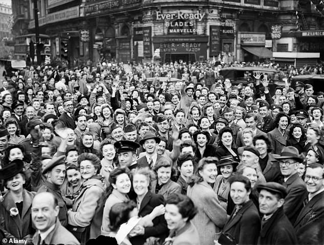 Pictured: VE Day celebrations in London at the end of the Second World War - huge crowds gathered around Piccadilly Circus during the celebrations