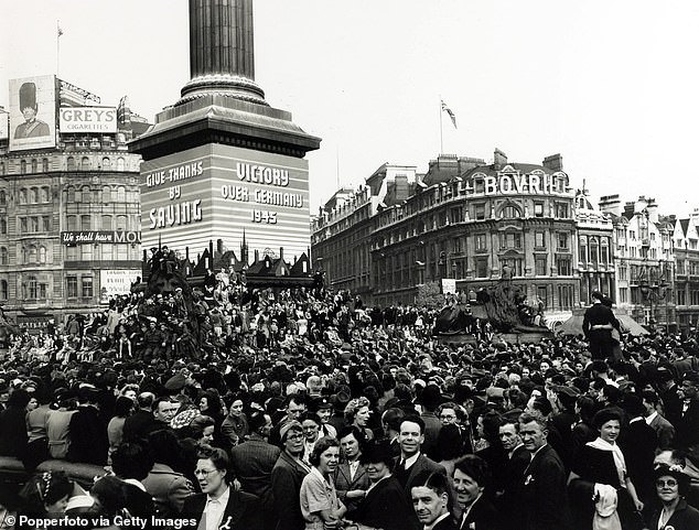 Pictured: Crowds gather in Trafalgar Square to celebrate VE Day, marking the end of European conflict in World War II