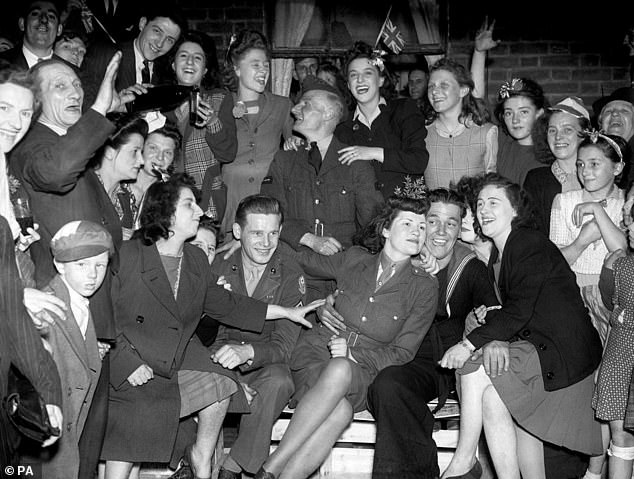 Pictured: A teenage Princess Elizabeth danced in jubilation on VE Day after slipping into the crowds unnoticed outside Buckingham Palace