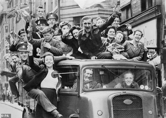 Pictured: A truck of revellers passing through the Strand in London following the announcement of Germany's surrender and the end of hostilities in Europe
