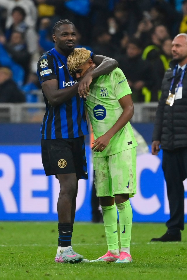 Marcus Thuram of FC Internazionale consoles Lamine Yamal of FC Barcelona after a match.