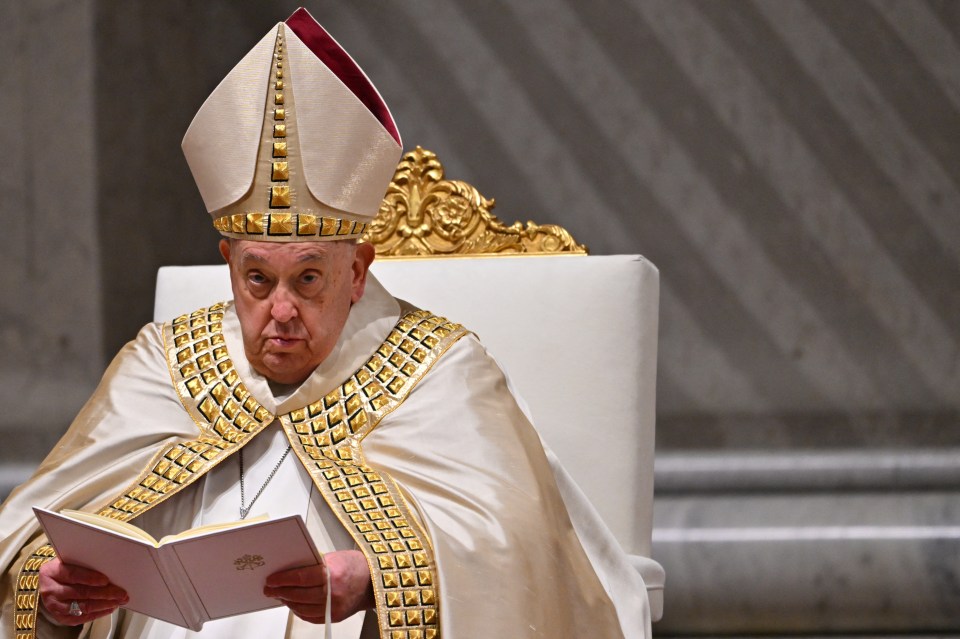 Pope Francis reading from a book during mass.