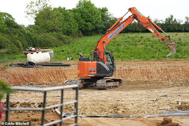 A digger is seen at the site where works without planning permission has been condemned