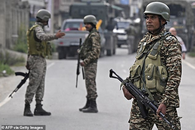 Indian security personnel stand guard in Wuyan near Srinagar on May 7, 2025