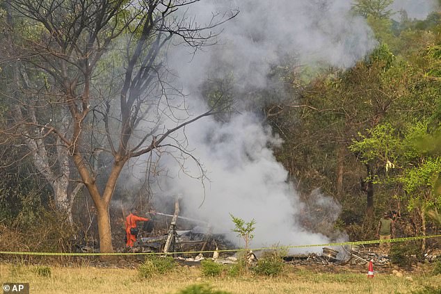 Fire fighters douse smoke coming out from the debris of an aircraft near Akhnoor on the outskirts of Jammu, India, Wednesday, May 7, 2025