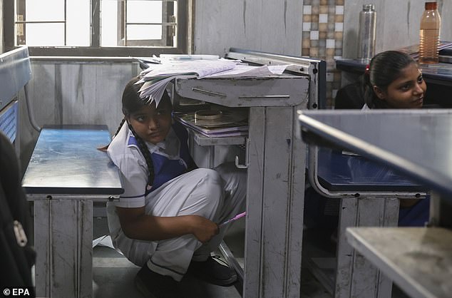 Indian school students take part in a mock drill at Rajkiya Sarvodaya Vidyalaya in New Delhi, India, May 7 2025