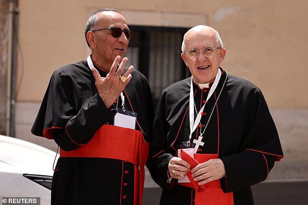 Cardinals Juan Jose Omella and Carlos Osoro Sierra talk, ahead of the conclave to elect the next pope, as seen from Rome, Italy