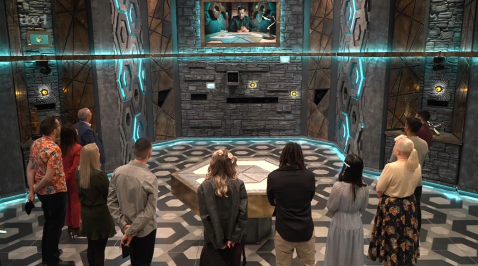 Contestants on a game show set surrounding a central game table.