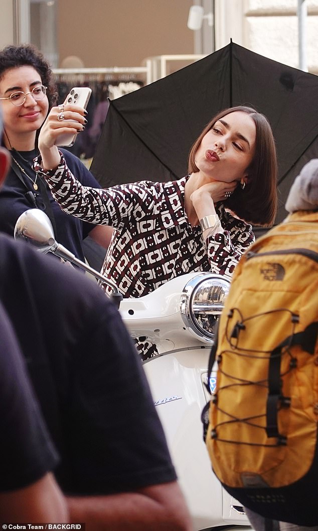 Emily pulled cute expressions for her pictures on her cream Vespa