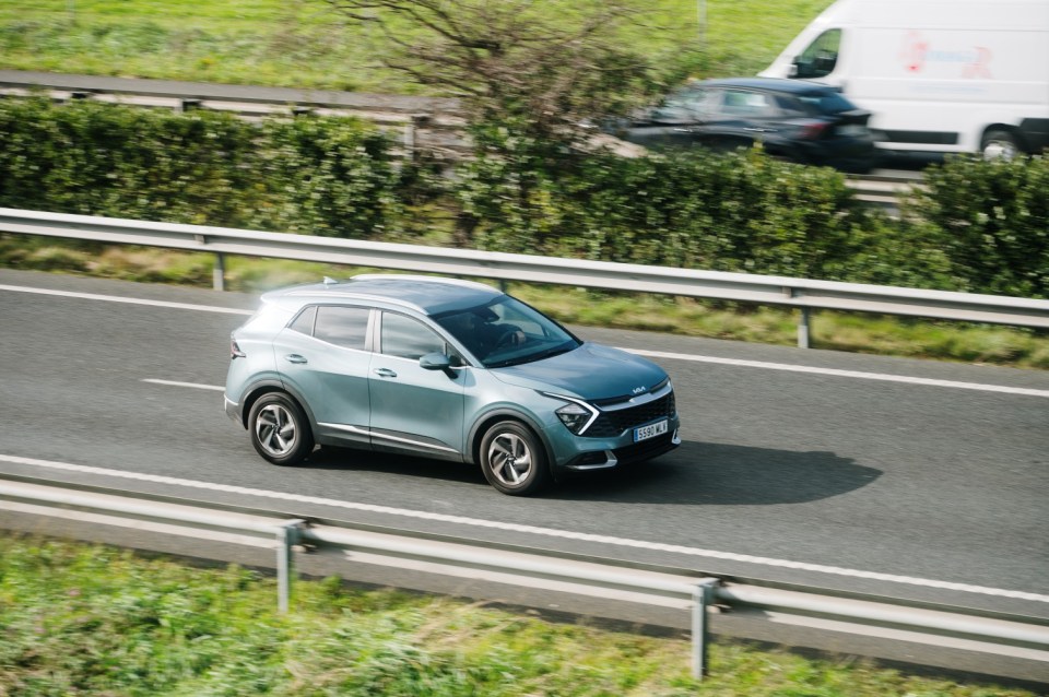 Kia Sportage driving on a highway.