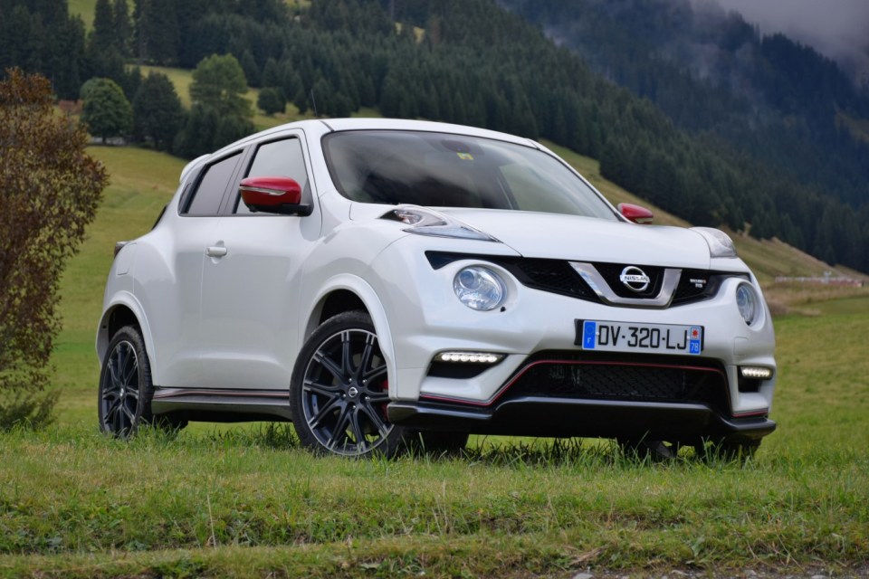 White Nissan Juke parked in a grassy field.