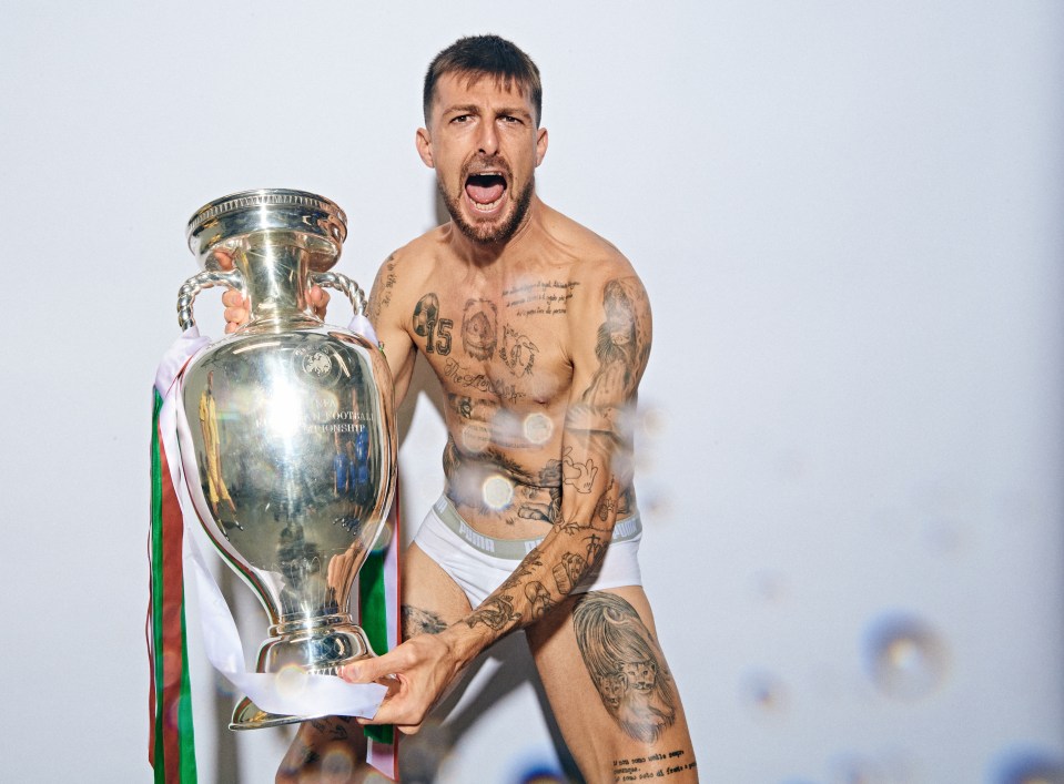 Francesco Acerbi holding the Henri Delaunay Trophy.