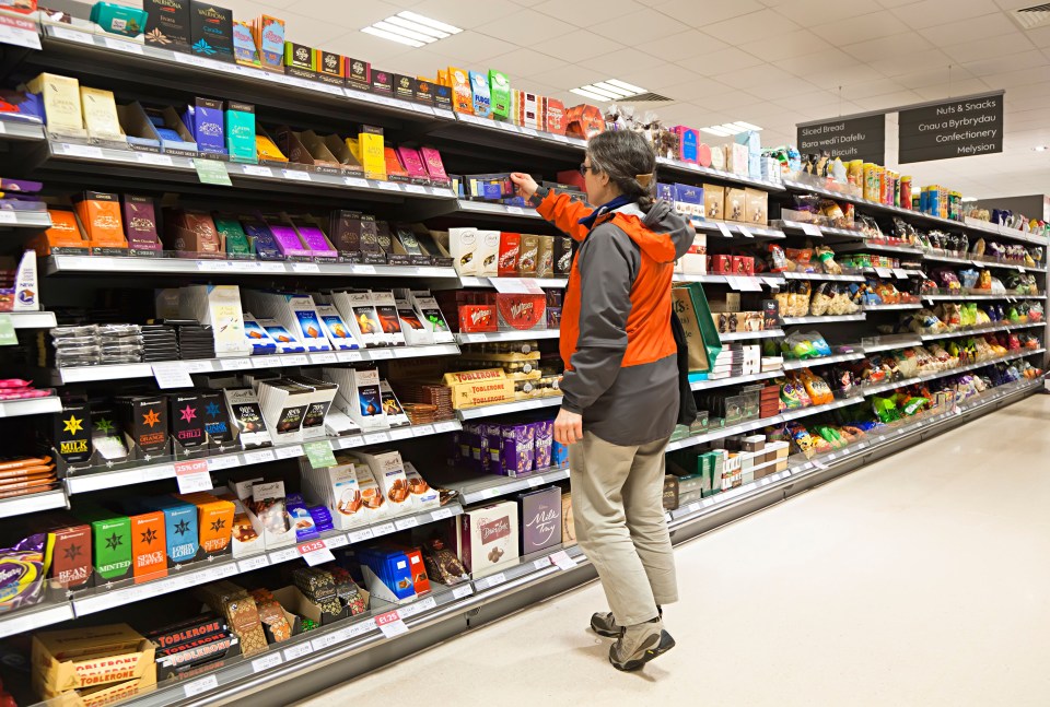Woman selecting chocolate in a supermarket.