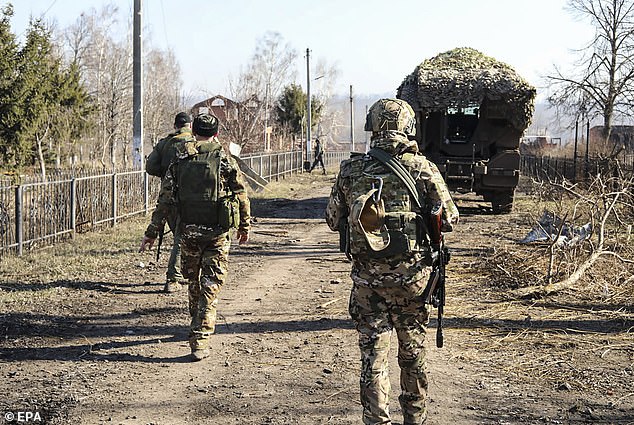 Russian servicemen walking along at an area in the Kursk region, Russia, 14 March