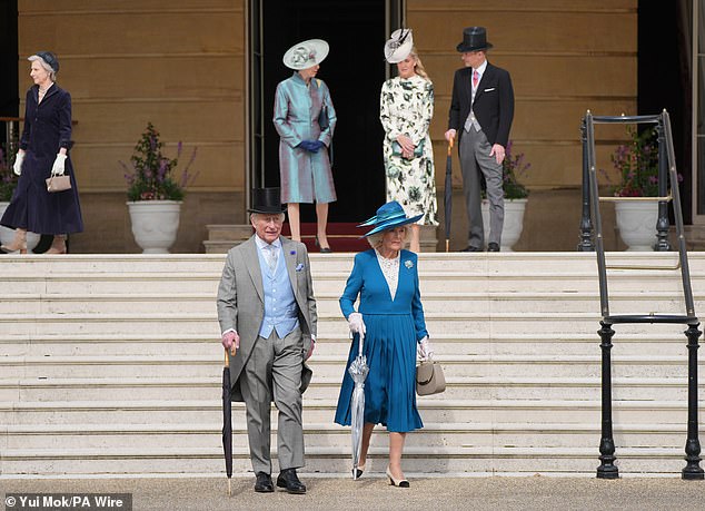 Charles and Camilla beamed as they walked around the picturesque gardens, chatting and greeting their many guests who were all dressed up for the elegant occasion