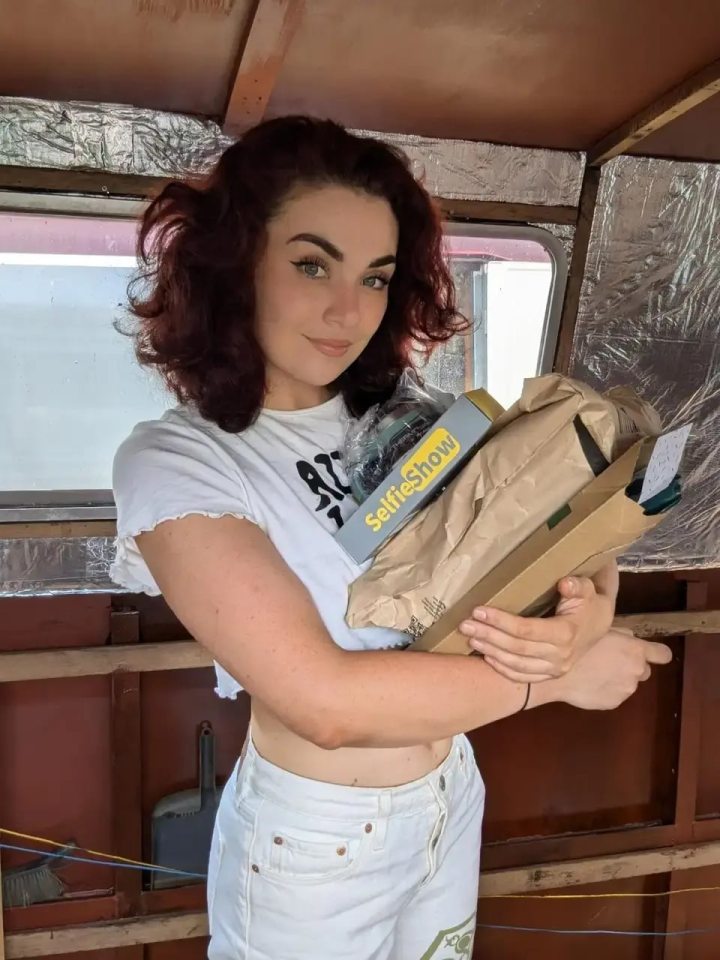 Woman holding packages inside a narrowboat.