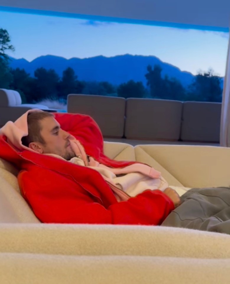 Justin Bieber relaxing on a couch.