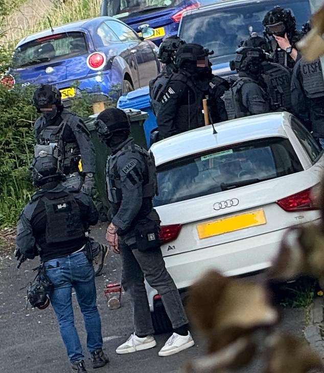 Pictured are a group of Counter Terrorism Specialist Firearms Officers outside a home in Rochdale during another raid on Saturday