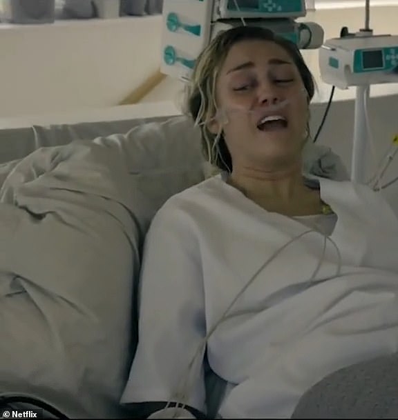 'Actually as my house was burning down I was strapped to a gurney with my hands locked in handcuffs strapped to a bed,' the More to Lose songstress recalled on TikTok