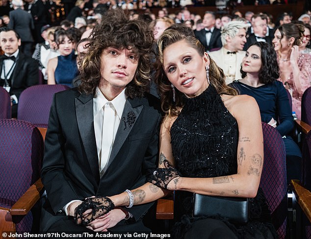 In 2021, Cyrus began dating Liily drummer Maxx Morando (L, pictured March 2), who's one of the eight producers credited on her upcoming album