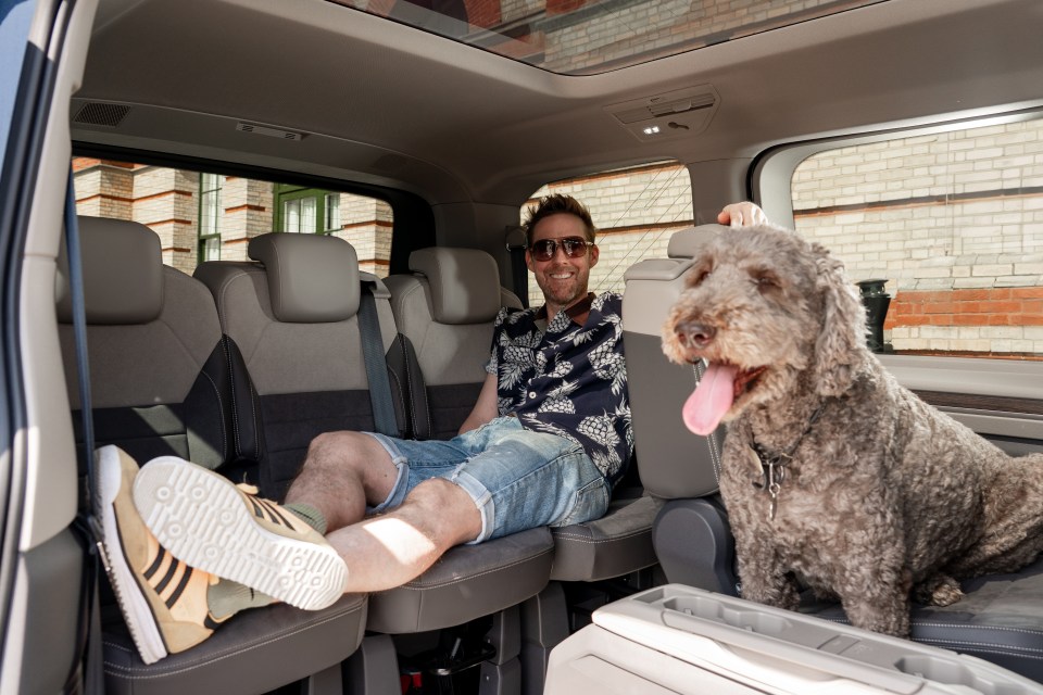 Man and dog in a VW Multivan.