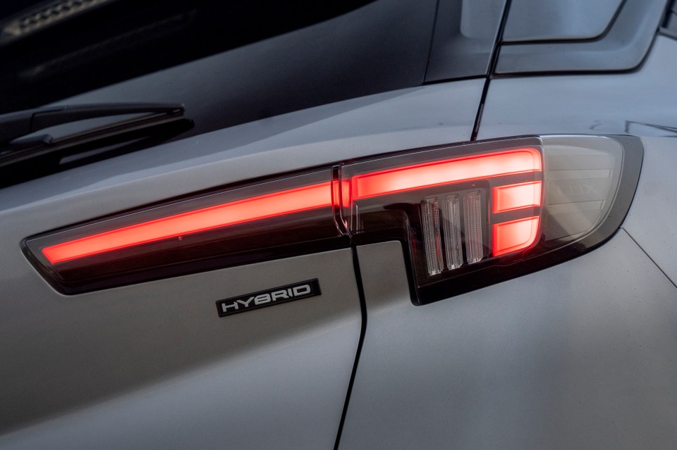 Close-up of a Vauxhall Mokka Hybrid 2025 taillight, showing the "Hybrid" emblem.