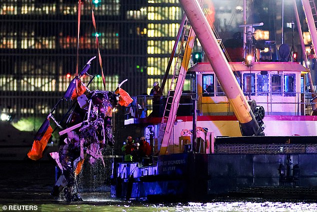 Emergency responders were seen pulling the remnants of the destroyed helicopter from the murky water of the Hudson River