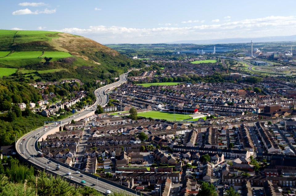 Aerial view of Port Talbot, Wales, showing the M4 motorway and surrounding residential areas.
