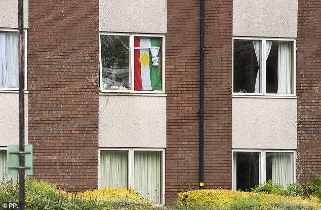 A Kurdistan flag can be seen draped in the windows of one of the hotel rooms